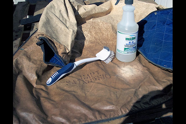 Spot on fire fighter's equipment bag by bottle cleaned with Ultra One G5.