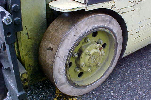 Impossible to clean solid white rubber forklift tire - before cleaning.