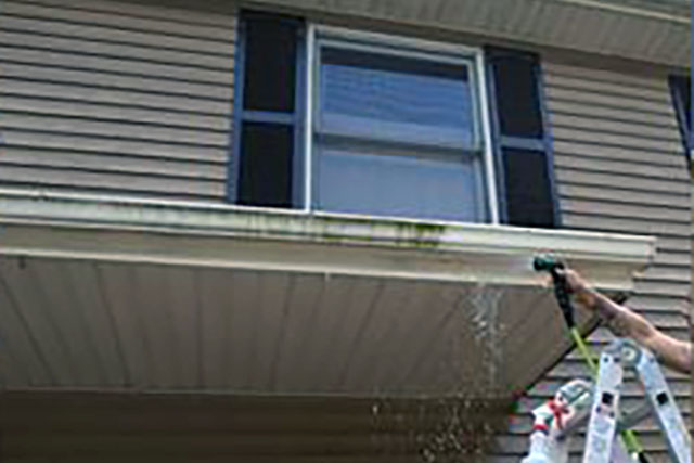 Cleaning a gutter with Ultra One Heavy Duty removes dirt and algae. The right side has been cleaned